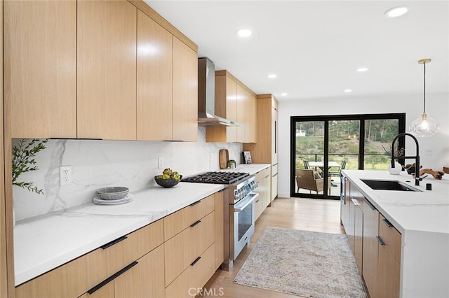 23912 Hillhurst Dr, Laguna Niguel, CA 92677 - kitchen featuring high end stainless steel range, wall chimney range hood, light brown cabinetry, recessed lighting, and modern cabinets