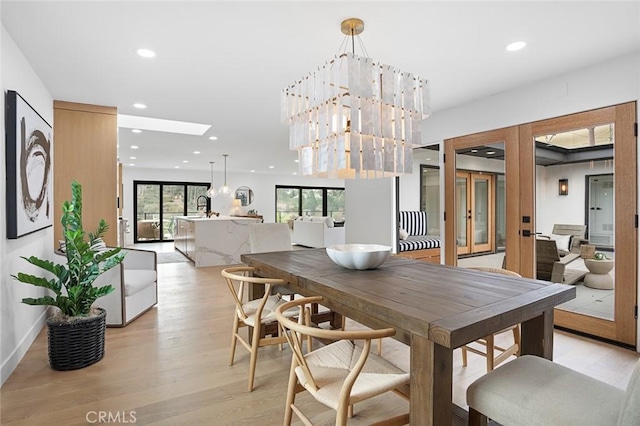 23912 Hillhurst Dr, Laguna Niguel, CA 92677 - dining area featuring recessed lighting, french doors, light wood-style flooring, and a skylight