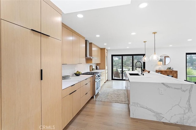 23912 Hillhurst Dr, Laguna Niguel, CA 92677 - kitchen with wall chimney exhaust hood, stainless steel stove, modern cabinets, light brown cabinetry, and recessed lighting