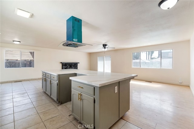 2738 S Fairway Ct, Visalia, CA 93277 - kitchen with gray cabinetry, a center island, a ceiling fan, and open floor plan