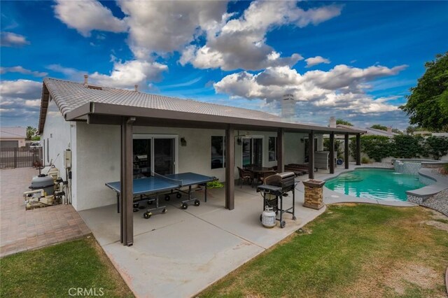 47645 Calle Diamante, Indio, CA 92201 - back of property with stucco siding, a tile roof, a patio area, and a chimney