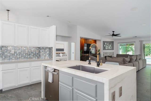 47645 Calle Diamante, Indio, CA 92201 - kitchen with vaulted ceiling, backsplash, ceiling fan, a kitchen island with sink, and white cabinets