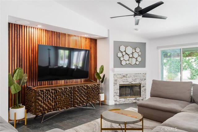 47645 Calle Diamante, Indio, CA 92201 - living area with stone finish floors, vaulted ceiling, ceiling fan, a glass covered fireplace, and recessed lighting