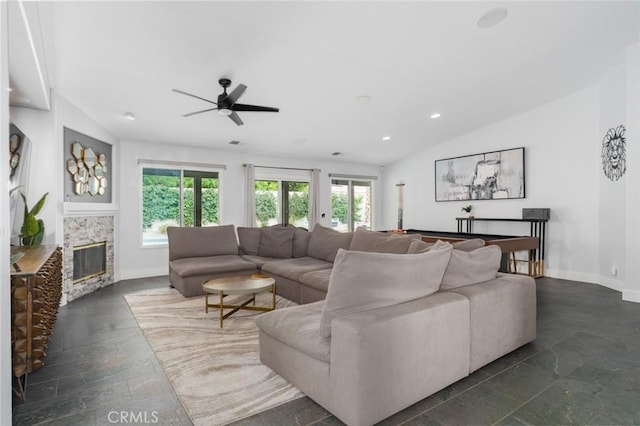 47645 Calle Diamante, Indio, CA 92201 - living area with lofted ceiling, ceiling fan, a glass covered fireplace, recessed lighting, and stone tile flooring