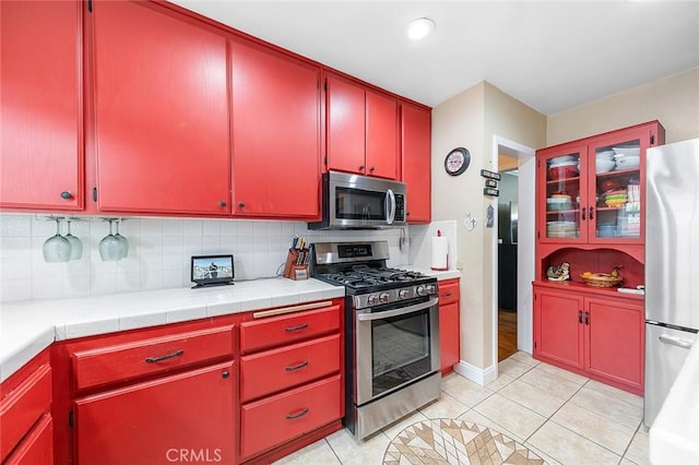 4303 E De Ora Way, Long Beach, CA 90815 - kitchen with appliances with stainless steel finishes, red cabinetry, decorative backsplash, and recessed lighting
