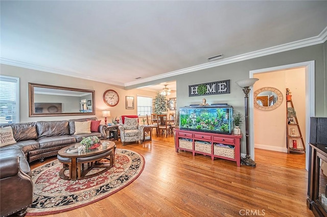 4303 E De Ora Way, Long Beach, CA 90815 - living area featuring a chandelier, wood finished floors, and crown molding