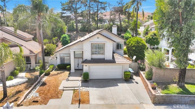 15030 Camino Arroyo, Chino Hills, CA 91709 - view of front of home featuring stucco siding, a garage, driveway, and a chimney