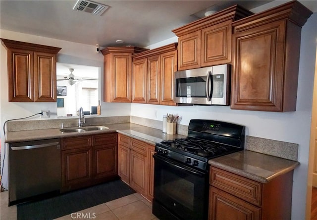8937 Palmetto Ave, Fontana, CA 92335 - kitchen featuring appliances with stainless steel finishes, brown cabinets, tile patterned flooring, and ceiling fan