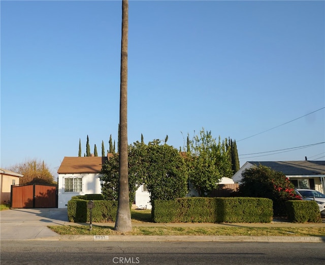 8937 Palmetto Ave, Fontana, CA 92335 - view of property hidden behind natural elements with stucco siding and driveway