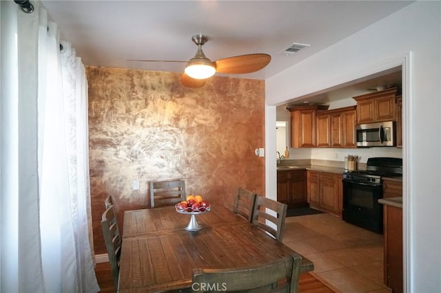 8937 Palmetto Ave, Fontana, CA 92335 - dining room featuring a ceiling fan and light tile patterned floors