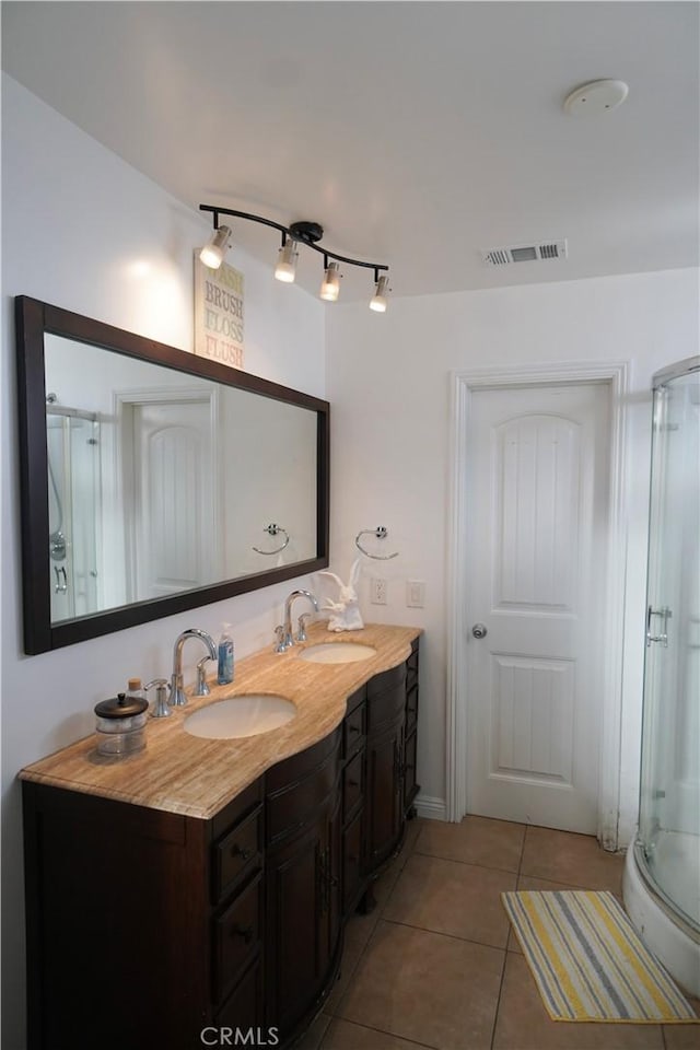 8937 Palmetto Ave, Fontana, CA 92335 - bathroom featuring tile patterned flooring, double vanity, and a stall shower