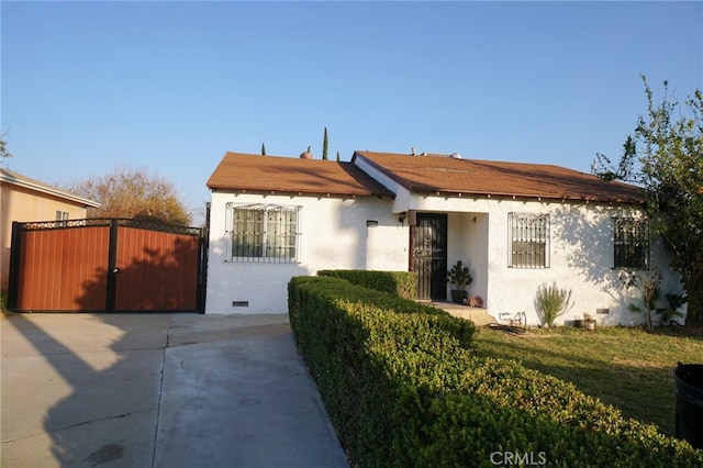 8937 Palmetto Ave, Fontana, CA 92335 - bungalow-style house with stucco siding, crawl space, and a gate