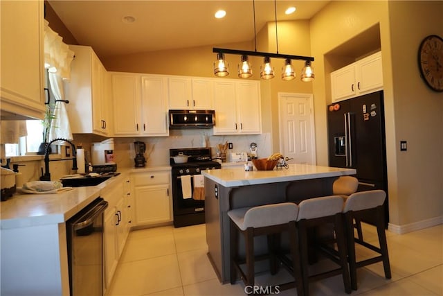 13115 Sunset Canyon Way, Victorville, CA 92395 - kitchen featuring black appliances, light tile patterned flooring, a kitchen breakfast bar, decorative backsplash, and white cabinets