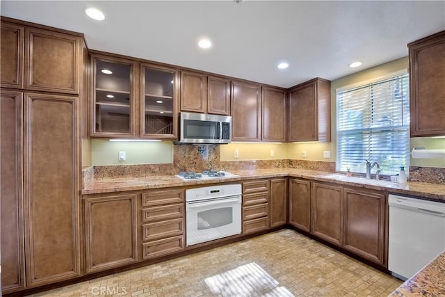 66 Glenalmond Ln, Ladera Ranch, CA 92694 - kitchen with white appliances, light stone counters, glass insert cabinets, and recessed lighting