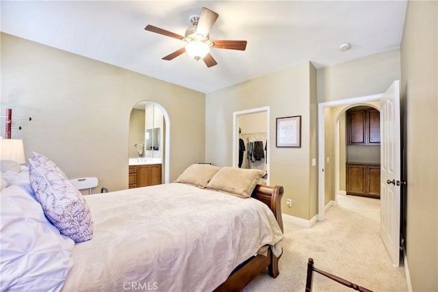 66 Glenalmond Ln, Ladera Ranch, CA 92694 - bedroom featuring arched walkways, light carpet, a walk in closet, a closet, and a ceiling fan