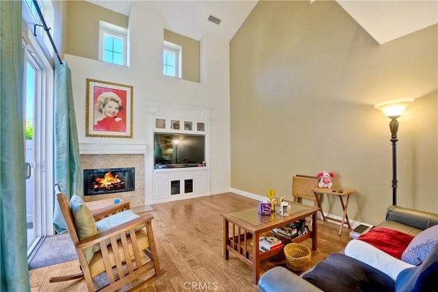 66 Glenalmond Ln, Ladera Ranch, CA 92694 - living room with wood finished floors, a multi sided fireplace, and high vaulted ceiling