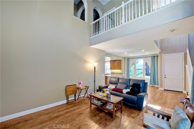 66 Glenalmond Ln, Ladera Ranch, CA 92694 - living room featuring light wood-style flooring and a high ceiling