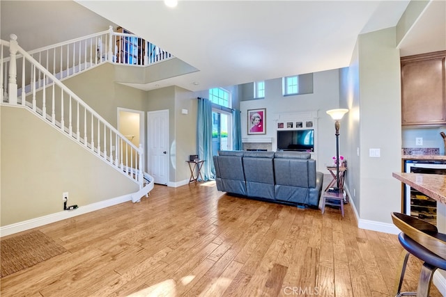 66 Glenalmond Ln, Ladera Ranch, CA 92694 - living area featuring stairs, light wood finished floors, and a high ceiling