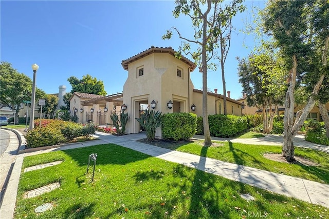 66 Glenalmond Ln, Ladera Ranch, CA 92694 - view of front of house featuring stucco siding, a front lawn, and a tile roof