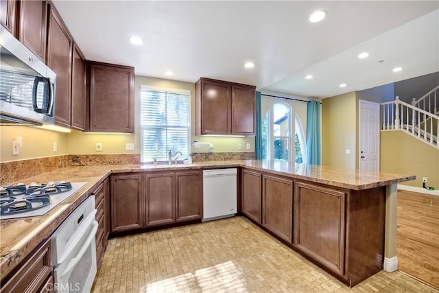 66 Glenalmond Ln, Ladera Ranch, CA 92694 - kitchen with white appliances, a peninsula, plenty of natural light, recessed lighting, and light stone counters