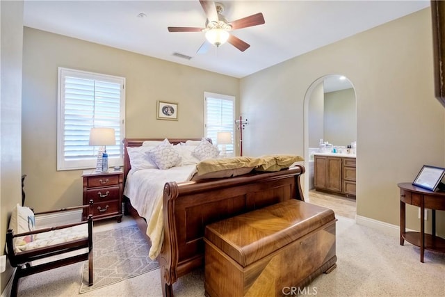 66 Glenalmond Ln, Ladera Ranch, CA 92694 - bedroom with arched walkways, connected bathroom, light colored carpet, and ceiling fan