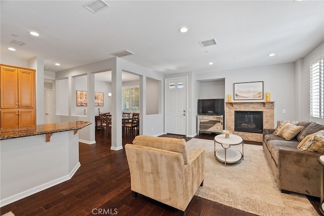 9441 Barstow Dr Unit 108, Rancho Cucamonga, CA 91730 - living room with dark wood-style flooring, healthy amount of natural light, a brick fireplace, and recessed lighting