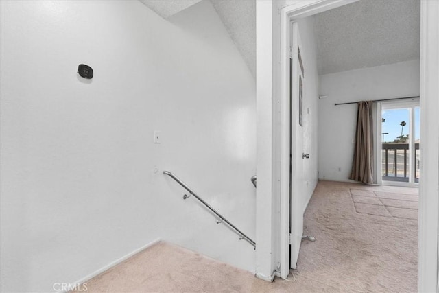 9100 Acacia Ave Unit 6, Fontana, CA 92335 - staircase featuring carpet floors and a textured ceiling