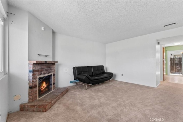 9100 Acacia Ave Unit 6, Fontana, CA 92335 - sitting room with carpet floors, a brick fireplace, and a textured ceiling