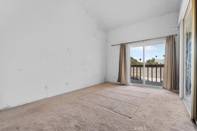 9100 Acacia Ave Unit 6, Fontana, CA 92335 - carpeted empty room featuring a textured ceiling and lofted ceiling