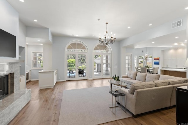 17124 Circa Oriente, Rancho Santa Fe, CA 92067 - living area with a chandelier, recessed lighting, light wood-type flooring, and a premium fireplace