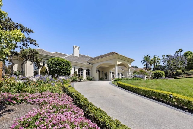 17124 Circa Oriente, Rancho Santa Fe, CA 92067 - mediterranean / spanish home featuring a chimney, curved driveway, and stucco siding