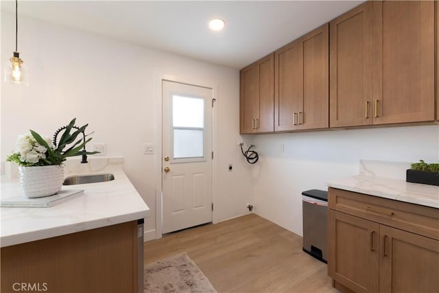 16509 Caballero Ln Unit 30B, Huntington Beach, CA 92649 - washroom with electric dryer hookup, hookup for a washing machine, light wood-style floors, cabinet space, and recessed lighting