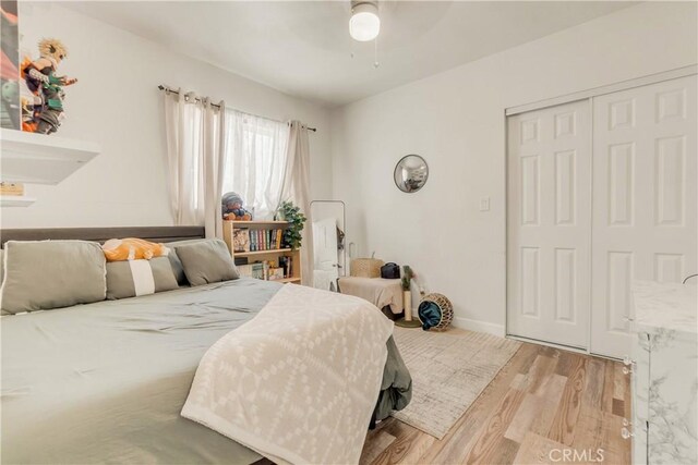 764 W 107th St, Los Angeles, CA 90044 - bedroom featuring light wood-style floors, a closet, and a ceiling fan