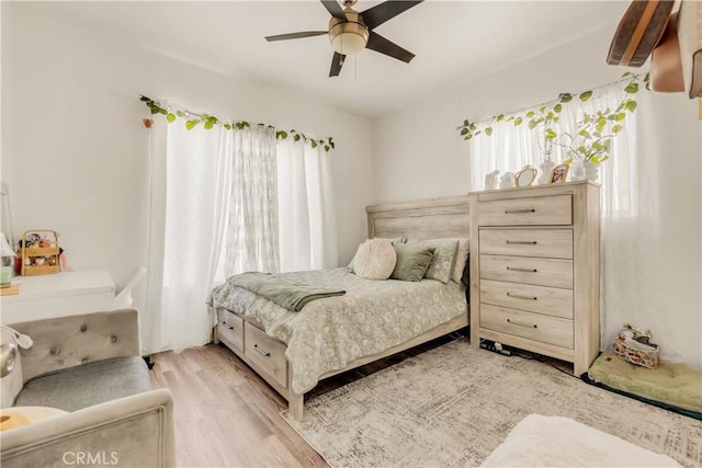 764 W 107th St, Los Angeles, CA 90044 - bedroom with multiple windows, light wood-style floors, and a ceiling fan