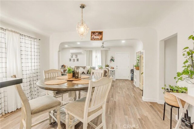 764 W 107th St, Los Angeles, CA 90044 - dining space featuring a wall unit AC and light wood-type flooring