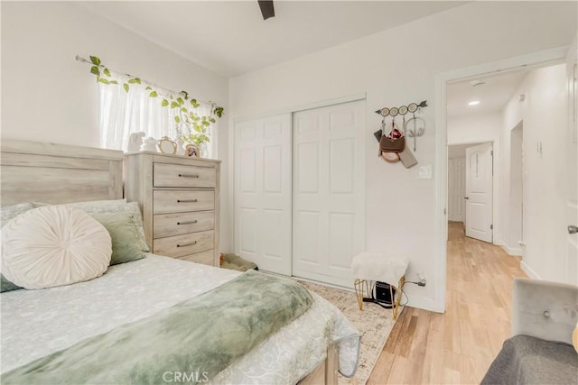 764 W 107th St, Los Angeles, CA 90044 - bedroom with light wood finished floors, a closet, and a ceiling fan