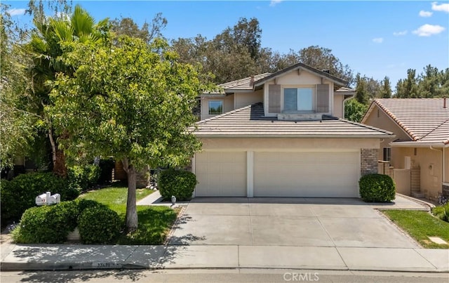 27628 Deerfield Ln, Valencia, CA 91354 - traditional-style house featuring driveway, a tiled roof, an attached garage, and stucco siding