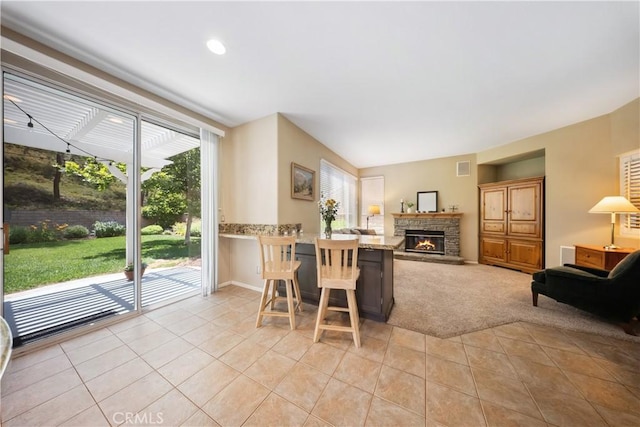 27628 Deerfield Ln, Valencia, CA 91354 - living room with light tile patterned floors, a stone fireplace, light carpet, and recessed lighting