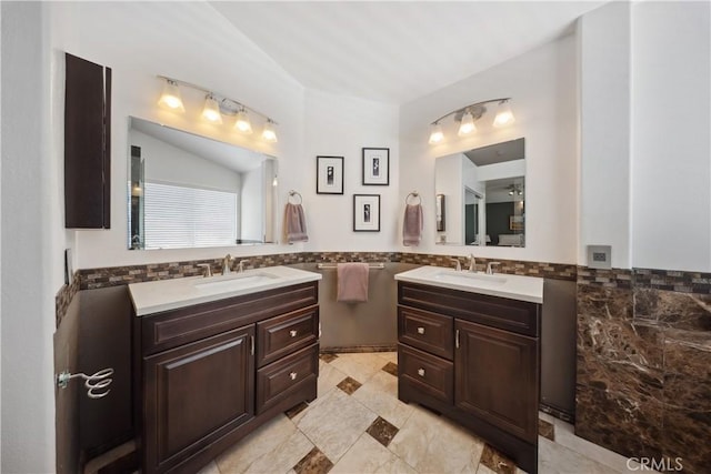 27628 Deerfield Ln, Valencia, CA 91354 - full bath featuring tile walls, two vanities, wainscoting, and vaulted ceiling