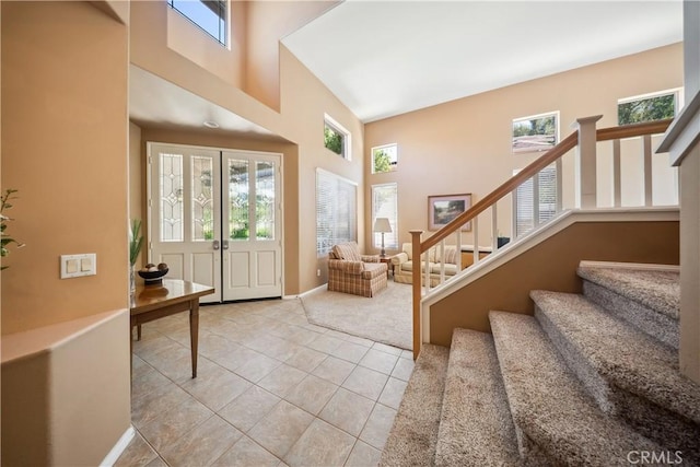 27628 Deerfield Ln, Valencia, CA 91354 - foyer entrance featuring a high ceiling, stairs, light tile patterned flooring, and light colored carpet