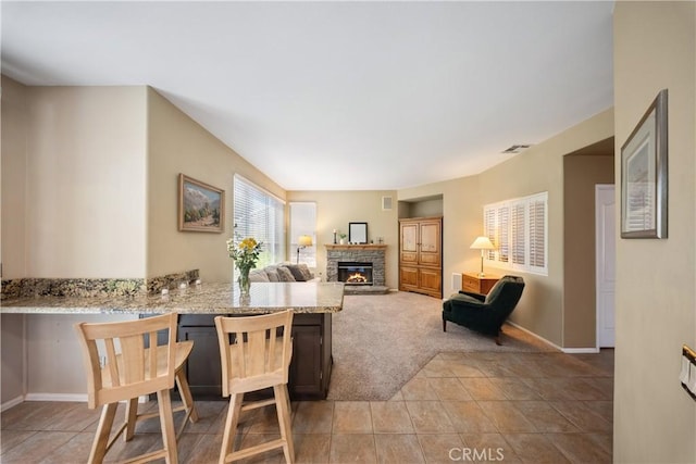 27628 Deerfield Ln, Valencia, CA 91354 - dining room featuring a stone fireplace and light carpet