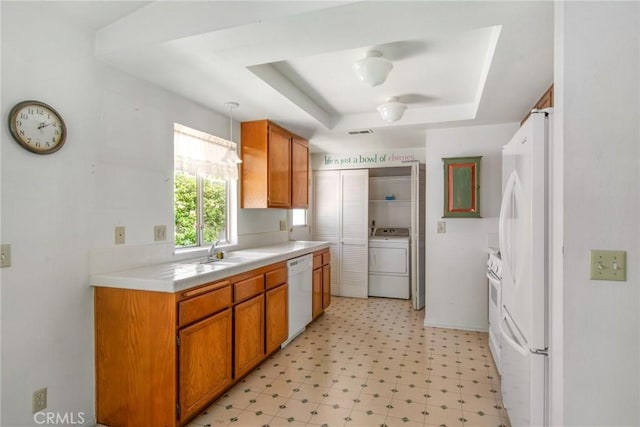 1050 Windmill Ln, Oak Park, CA 91377 - kitchen with washer / clothes dryer, white appliances, a tray ceiling, light countertops, and light floors