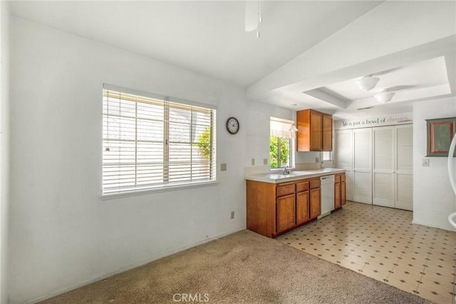 1050 Windmill Ln, Oak Park, CA 91377 - kitchen featuring white dishwasher, a tray ceiling, light countertops, and brown cabinets