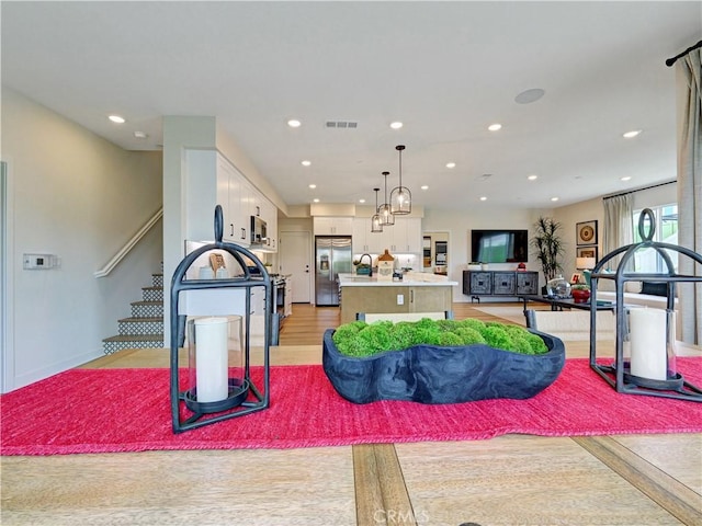 17151 Kent St, Hesperia, CA 92345 - living room with recessed lighting, stairway, and light wood-style floors