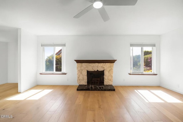 2325 Parkway Dr, Camarillo, CA 93010 - unfurnished living room featuring wood finished floors, a ceiling fan, and a stone fireplace