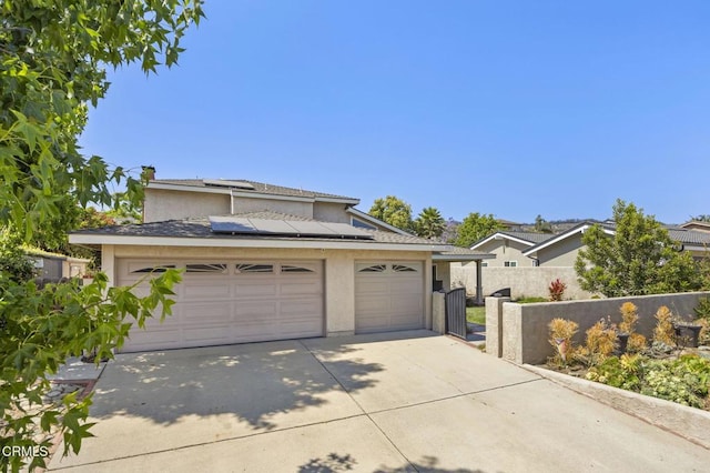 2325 Parkway Dr, Camarillo, CA 93010 - traditional-style house with concrete driveway, stucco siding, roof mounted solar panels, and an attached garage