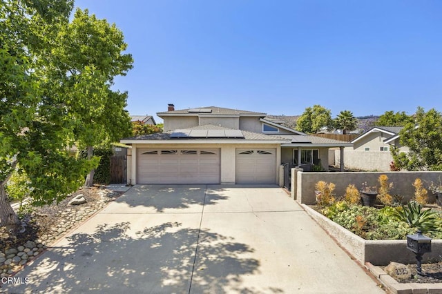 2325 Parkway Dr, Camarillo, CA 93010 - traditional-style home featuring driveway, an attached garage, stucco siding, and solar panels