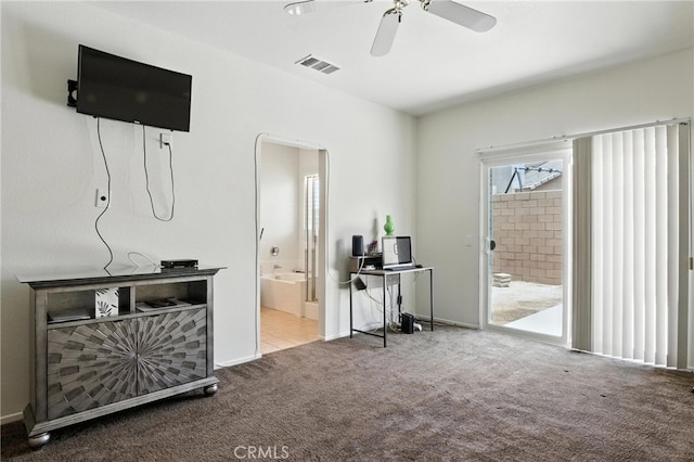 13525 Evanston St, Victorville, CA 92392 - carpeted bedroom featuring connected bathroom, arched walkways, access to outside, an office area, and ceiling fan