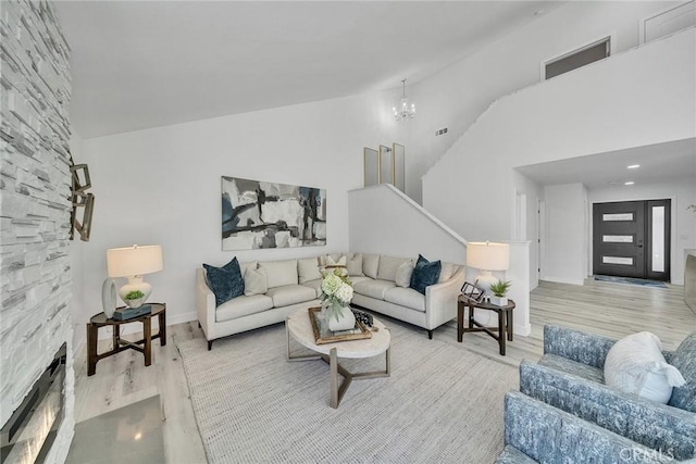39 Cape Cod, Irvine, CA 92620 - living room featuring wood finished floors, high vaulted ceiling, and a chandelier