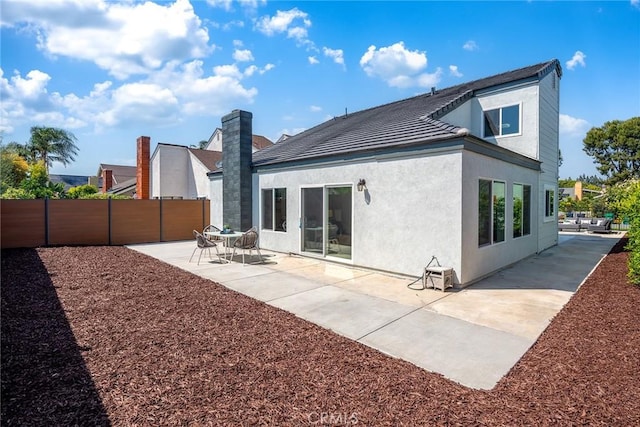39 Cape Cod, Irvine, CA 92620 - rear view of house with a patio area, stucco siding, and a tile roof